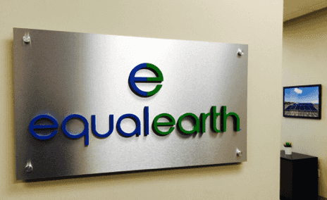 An aluminum lobby sign with individual dimensional letters applied to the surface. Company logotype and logo and are custom painted in bright colors. Also standard brushed aluminum hardware in the corners for mounting on lobby wall.